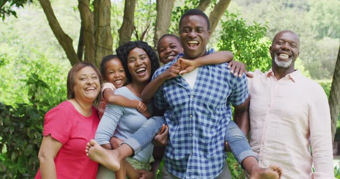 Happy african american multigeneration family posing to photo in garden