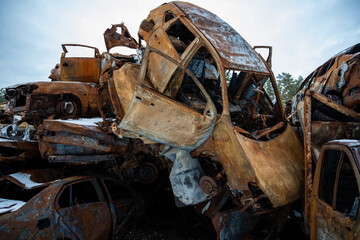 Fototapeta premium Stacked a bunch of crashed cars after fire and missiles attacks in town