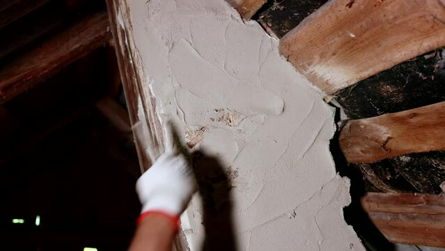 The stovepipe plasterer is plastering the wall of the stove pipe.