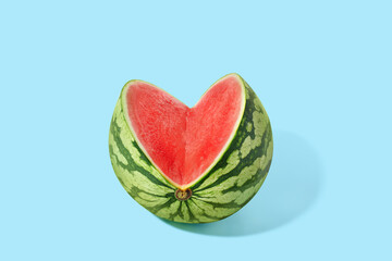 Cut watermelon on blue pastel background