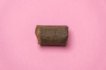 Ice-o-lator, bubble hash, water hash, medical marijuana extraction dry hashish cannabis pollen on a pink background.