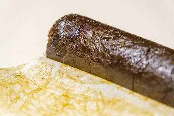 Indian Manali Charas, high quality resin hashish on a white background. Medical marijuana extraction hash cannabis pollen oil