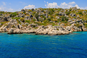 View of the rocky shore from the sea. Mediterranean Sea in Turkey. Popular tourist places. Background