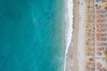 Straight down view on parasols and beach by Bunec Beach area in Summer 2022, Albania