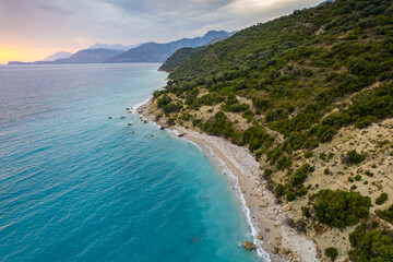 Fototapeta na wymiar Aerial view of green shore with huge rocks by Bunec Beach area in Summer 2022, Albania
