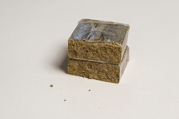 Hashish stick ready for sale on a white background. Medical marijuana extraction zkittlez dry hash...