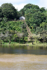 small house on the banks of the amazon river
