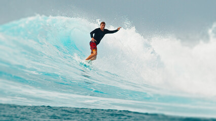 Surfer rides the wave during day