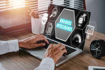Business intelligence concept, Businees person working on laptop computer with business intelligence icon on virtual screen, data mining, analysis, measurement, benchmarking, report and management.
