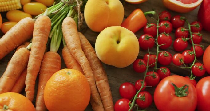 Video of fresh fruit and vegetables over wooden background