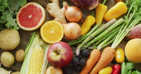 Video of fresh fruit and vegetables over wooden background - Powered by Adobe