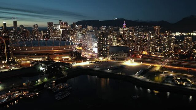 Aerial hyperlapse of night cityline with skyscrapers. Vancouver, Canada.