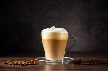 Cups of coffee drink, latte or mocha with milk foam. Glass mug, dark wooden background