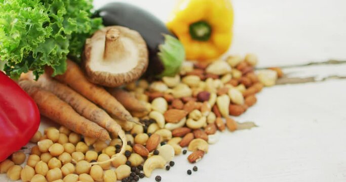 Video of fresh vegetables and seeds over white background