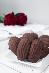 Chocolate madeleines on a ceramic plate, plain chocolate madeleine cake or cookies