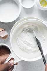 Sifting flour for baking, a plastic sieve with flour in it