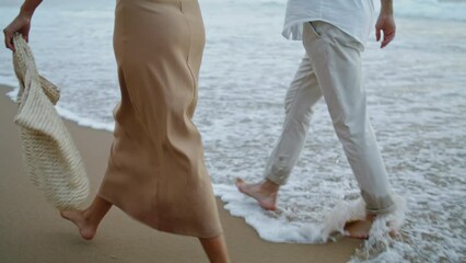 Sweethearts feet running sand beach at sea vacation. Couple walking on shore 