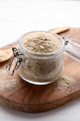 Beer yeast flakes on white wooden table, closeup