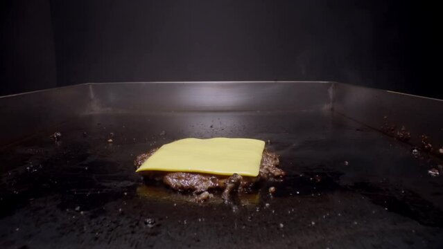 Cheeseburger preparation process in restaurant kitchen