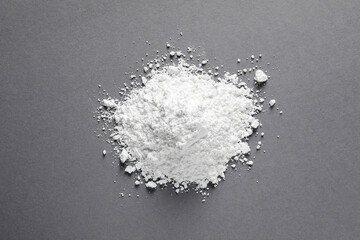 Fototapeta na wymiar Heap of calcium carbonate powder on grey table, top view