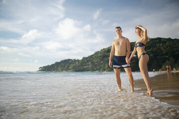 Fototapeta na wymiar young couple on the beach, romantic person summer sea vacation