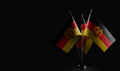 Small national flags of the DDR on a black background