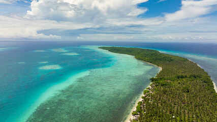 Tropical island with beach and palm trees. Canabungan Island, Balabac, Palawan. Philippines.