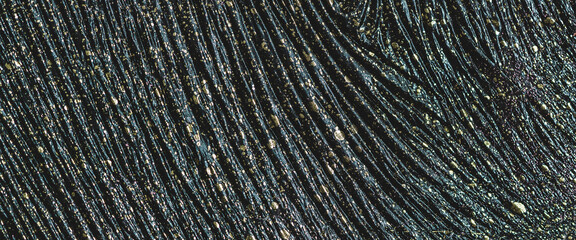 Fluid art background of black color with gilding. Wrinkled effect of black liquid ink with gold drops. Extraterrestrial skin with golden stains. Abstract black texture of acrylic paints with gold dust