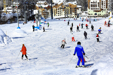 ski slope a lot of skiers background blurred