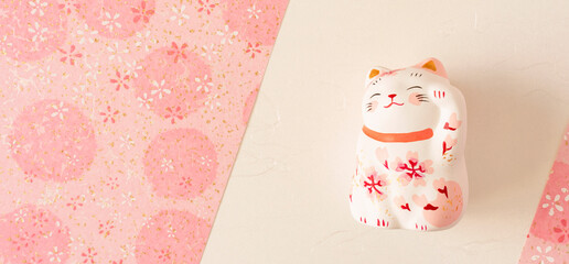 Background material to celebrate spring. Sakura Japanese paper and cat brings luck. Spring,...