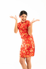 young asian woman in red cheongsam standing cross legged raise her hands and smiling