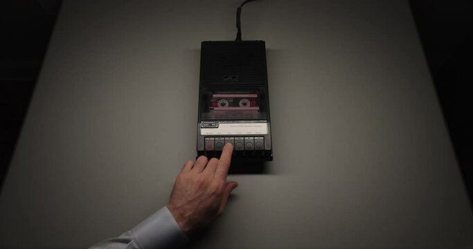 Analog Cassette Tape Being Inserted And Played In Recorder Sitting On Table