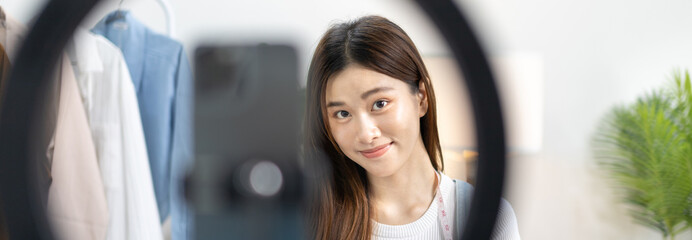 Beautiful woman with a social media influence is greeting the audience for recording vlog video...