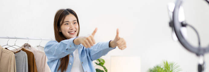 Beautiful woman with a social media influence is greeting the audience for recording vlog video...