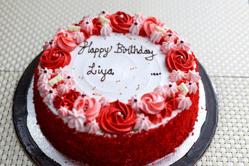 Slice of Red Velvet cake on white plate. Flower cake.  Wedding dessert. Birthday party. Delicious dessert in Kerala India. Indian sweet food