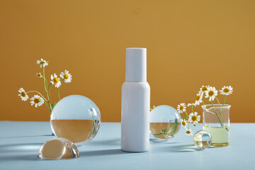 Mockup scene with empty bottle for cosmetics of feverfew (tanacetum parthenium) extract on yellow...