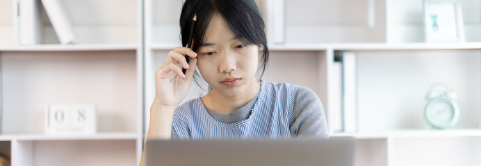 Young studying online uses his laptop in a live performance to communicate with his friends and teachers, Using laptops and data graphs in class, Online communication, Social distancing.