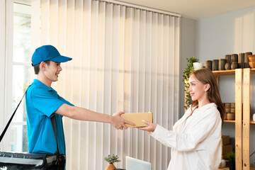 Caucasian young girl shopping online and receive order from delivery man in blue uniform with...