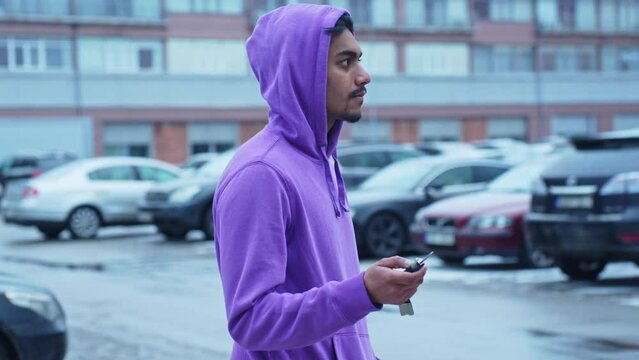 Medium Close Up Of Young Man Wearing Purple Hoodie Looking For Car With Key