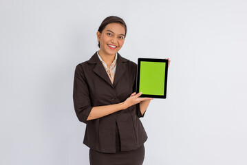 beautiful woman in formal outfit showing the digital tablet with green screen on isolated background