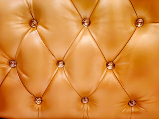 Brown buttoned luxury leather pattern with diamonds and gemstones. Useful as luxury pattern