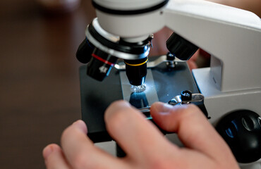 Microscope close-up. research under magnification. Amateur microscope for home study. scientific equipment
