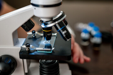 Microscope close-up. research under magnification. Amateur microscope for home study. scientific equipment