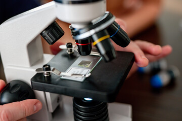 Microscope close-up. research under magnification. Amateur microscope for home study. scientific equipment