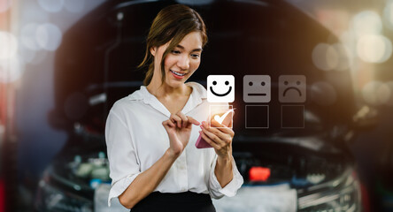 Asian woman use smartphone to give excellent experience rating review with smile icon