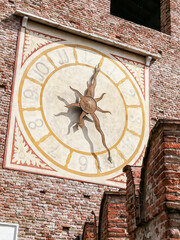 The large decorative clock on the entrance tower to the Castelvecchio Castello Scaligero fortress in Verona, Italy.