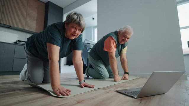 Happy Aged Spouses Doing Sport At Home, Stay Healthy And Active In Old Age, Watching Online Workout