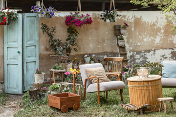 a cozy place to relax with a retro-style armchair in the backyard of a country house on a sunny...