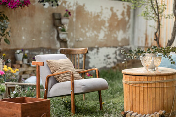 a cozy place to relax with a retro-style armchair in the backyard of a country house on a sunny spring day