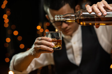 Barman pouring whiskey whiskey glass beautiful night